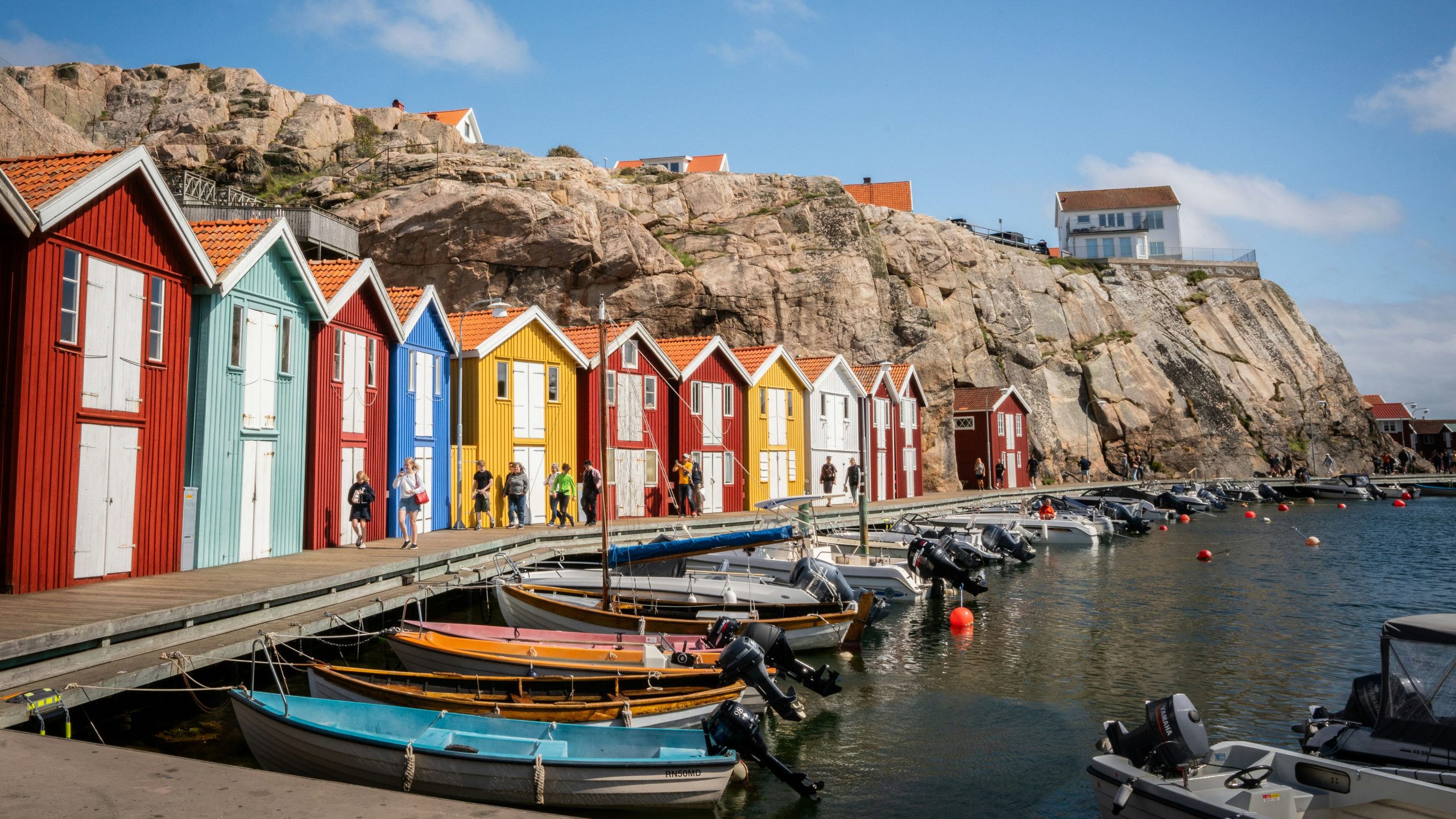 Image shows colourful fisherman's huts on the Swedish coast